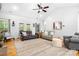 Spacious living room featuring a plush rug, ceiling fan, and ample seating, creating a warm and inviting atmosphere at 730 Oak Ridge Farms Cir # 14, Newton, NC 28658