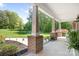 Covered porch with brick pillars, blending outdoor tranquility with architectural charm at 730 Oak Ridge Farms Cir # 14, Newton, NC 28658