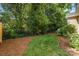 The lush backyard features manicured landscaping and a tranquil setting perfect for outdoor enjoyment and relaxation at 752 Pinebough Ln, Rock Hill, SC 29732