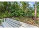 The tranquil backyard features mature trees providing privacy and a bench for relaxation at 752 Pinebough Ln, Rock Hill, SC 29732