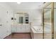 Bright bathroom featuring a soaking tub and separate shower, complemented by a vanity with ample storage at 752 Pinebough Ln, Rock Hill, SC 29732