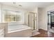 Bright bathroom featuring a soaking tub and separate shower, complemented by a vanity with ample storage at 752 Pinebough Ln, Rock Hill, SC 29732