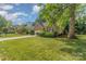 A lush front lawn is framed by mature trees, enhancing the property's curb appeal and natural beauty at 752 Pinebough Ln, Rock Hill, SC 29732