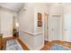 Inviting hallway with wood flooring and classic trim, featuring doorways and framed artwork at 752 Pinebough Ln, Rock Hill, SC 29732