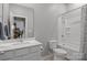 Clean bathroom featuring a white vanity, toilet, and shower-tub combo with a shower curtain at 7620 Porrera St, Charlotte, NC 28214