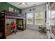 Cozy bedroom with bunk bed, desk, and window view to the backyard at 7620 Porrera St, Charlotte, NC 28214