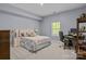 Comfortable bedroom with neutral carpet and a dedicated workspace by the window at 7620 Porrera St, Charlotte, NC 28214