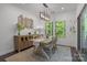 Dining room with natural light, wooden table, and accent wall decor at 7620 Porrera St, Charlotte, NC 28214