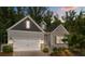 Charming home featuring a blend of stone and siding, a two-car garage, and a beautifully landscaped front yard at 7620 Porrera St, Charlotte, NC 28214