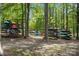 Outdoor storage racks filled with colorful kayaks, surrounded by a tranquil wooded setting at 7620 Porrera St, Charlotte, NC 28214