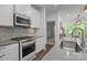 Modern kitchen with stainless steel appliances and quartz countertops at 7620 Porrera St, Charlotte, NC 28214