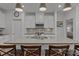 Well-lit kitchen featuring white cabinets, stainless steel appliances, a large island, and elegant pendant lights at 7620 Porrera St, Charlotte, NC 28214