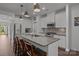 Bright kitchen with white cabinets, a large island, modern appliances, and stylish pendant lighting at 7620 Porrera St, Charlotte, NC 28214