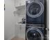 Convenient laundry room featuring modern stacked washer and dryer with ample storage space at 7620 Porrera St, Charlotte, NC 28214