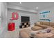 Finished basement with a television, mini fridge, sectional sofa, and decor at 7620 Porrera St, Charlotte, NC 28214