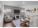 Comfortable living room featuring a fireplace, lots of seating, and great natural light at 7620 Porrera St, Charlotte, NC 28214