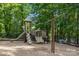 Community playground featuring a slide and swings, surrounded by mature trees at 7620 Porrera St, Charlotte, NC 28214