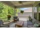 Covered back porch with outdoor seating, ceiling fan, and a view of the backyard at 7620 Porrera St, Charlotte, NC 28214