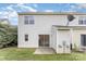 View of the back exterior showing the back patio, storage and sliding glass door at 7718 Petrea Ln, Charlotte, NC 28227