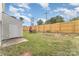 Spacious backyard featuring a charming outdoor dining area and storage shed at 7718 Petrea Ln, Charlotte, NC 28227