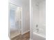Bathroom featuring tub/shower combo and wood-look flooring at 7718 Petrea Ln, Charlotte, NC 28227