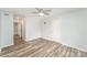 View of the bedroom with an ensuite bathroom, wood-look flooring, and neutral walls at 7718 Petrea Ln, Charlotte, NC 28227