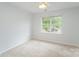 Bedroom with plush carpet, ceiling fan, and a window with natural light at 7718 Petrea Ln, Charlotte, NC 28227