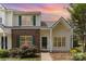 Charming townhome featuring a brick accent wall, green shutters, and well-maintained landscaping at 7718 Petrea Ln, Charlotte, NC 28227