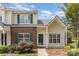 Charming townhome featuring a brick accent wall, green shutters, and well-maintained landscaping at 7718 Petrea Ln, Charlotte, NC 28227