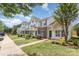 View of townhomes with green shutters and landscaping, creating a welcoming neighborhood street at 7718 Petrea Ln, Charlotte, NC 28227