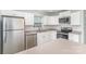 Bright kitchen featuring stainless steel appliances, white cabinetry, and a view of the open layout at 7718 Petrea Ln, Charlotte, NC 28227