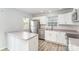 Well-lit kitchen with stainless steel appliances and white cabinets, showcasing a clean and modern design at 7718 Petrea Ln, Charlotte, NC 28227