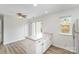 Kitchen area featuring a central island, white cabinets, and a sliding door leading to the outside at 7718 Petrea Ln, Charlotte, NC 28227