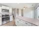 Spacious kitchen with stainless steel oven and microwave, white cabinetry and an island with countertop at 7718 Petrea Ln, Charlotte, NC 28227