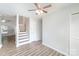 Living room area with a view of the staircase and a closet, offering a glimpse into the home's layout at 7718 Petrea Ln, Charlotte, NC 28227