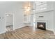 Bright living room with hardwood floors, fireplace, and an open floor plan at 7718 Petrea Ln, Charlotte, NC 28227