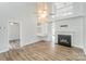 Bright living room with hardwood floors, fireplace, and an open floor plan at 7718 Petrea Ln, Charlotte, NC 28227