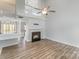 Bright living room with hardwood floors, fireplace, and an open floor plan at 7718 Petrea Ln, Charlotte, NC 28227