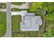 Aerial view of a well-maintained home, showcasing the roof, driveway, and landscaped backyard at 7730 Burning Ridge Dr, Stanley, NC 28164