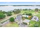 Breathtaking aerial view of golf course, pool, lake and clubhouse, promising luxury and leisure at 7730 Burning Ridge Dr, Stanley, NC 28164