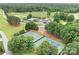 Stunning aerial view of tennis courts, clubhouse, and golf course, promising an active lifestyle at 7730 Burning Ridge Dr, Stanley, NC 28164
