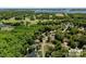 Expansive aerial view showcasing a lush community, golf course, and beautiful waterfront property at 7730 Burning Ridge Dr, Stanley, NC 28164