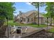 Inviting backyard patio with a modern firepit and comfortable seating, ideal for outdoor gatherings at 7730 Burning Ridge Dr, Stanley, NC 28164