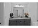 Bathroom featuring a gray vanity, light countertop, brushed silver hardware, and gray cabinets at 7730 Burning Ridge Dr, Stanley, NC 28164