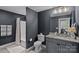 Modern bathroom featuring a gray vanity, granite countertop, and shower with a tub at 7730 Burning Ridge Dr, Stanley, NC 28164