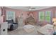 Adorable Bedroom with pink walls, a crib with canopy, and a comfortable glider at 7730 Burning Ridge Dr, Stanley, NC 28164