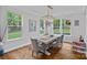 Cozy dining room with hardwood floors, large windows, and a modern chandelier at 7730 Burning Ridge Dr, Stanley, NC 28164