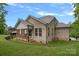 Well-maintained brick home with a covered porch, a spacious deck, and a beautifully landscaped yard at 7730 Burning Ridge Dr, Stanley, NC 28164