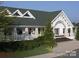 Attractive clubhouse with white siding, columns, covered porch, and well-manicured landscaping at 7730 Burning Ridge Dr, Stanley, NC 28164