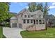 Stately brick home with a welcoming front porch, multiple garage spaces, and professional landscaping at 7730 Burning Ridge Dr, Stanley, NC 28164